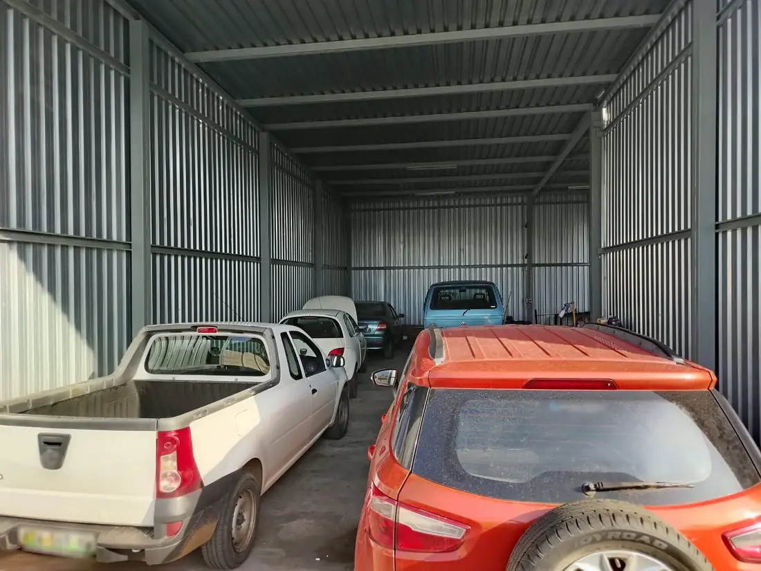 Inside the JHH Auto Worx workshop, with vehicles parked under the roof